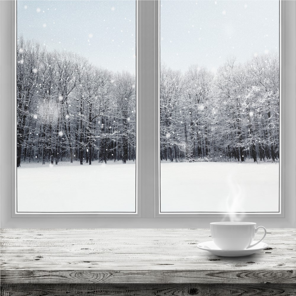Coffee cup on window sill on a snowy day