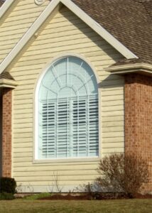 Yellow house with arched window