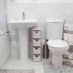 in an older house, a small bathroom has been updated with a light white modern clean feel