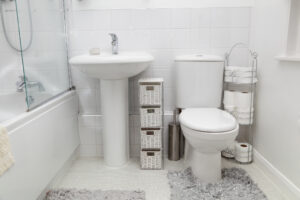 in an older house, a small bathroom has been updated with a light white modern clean feel