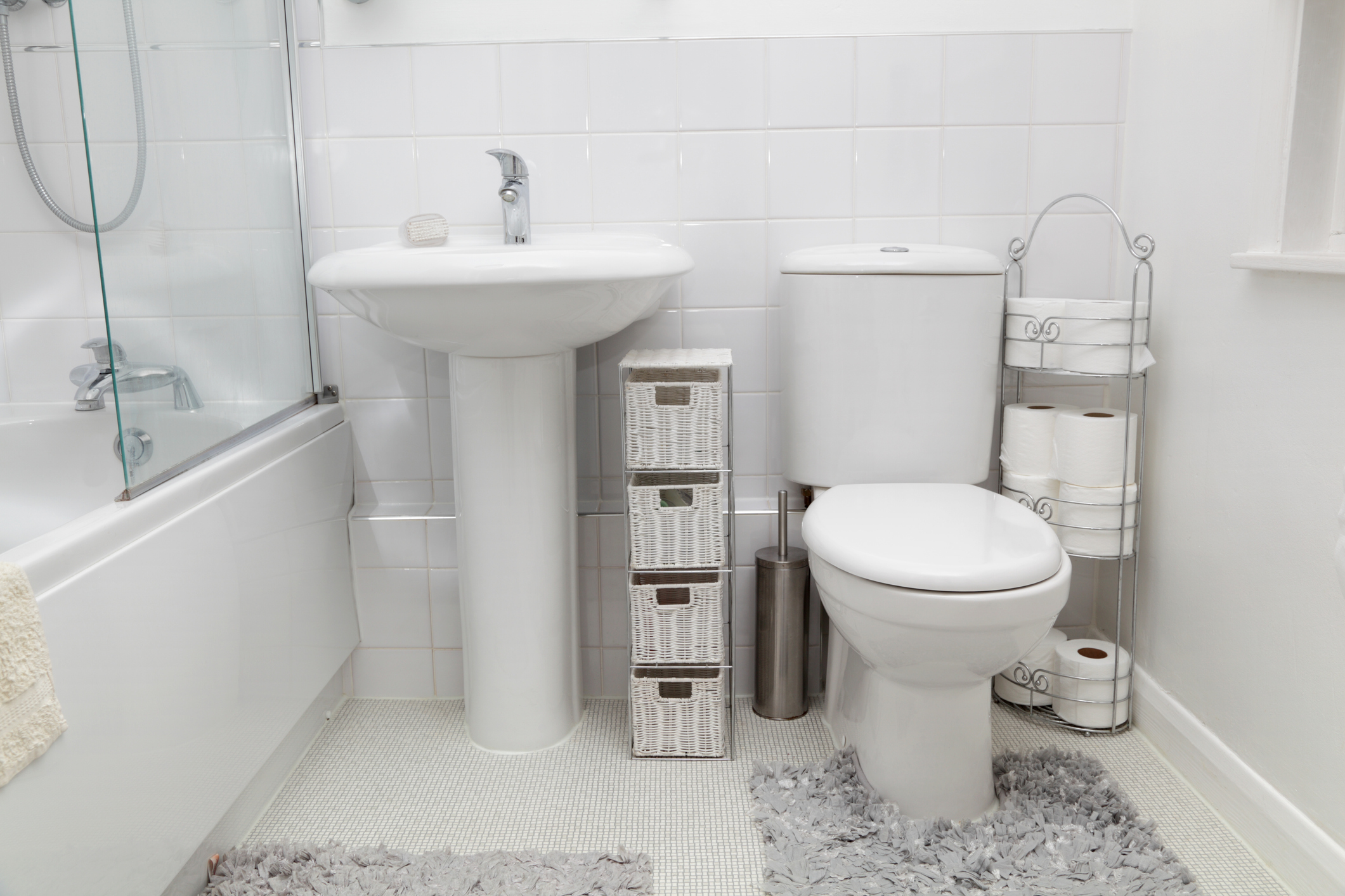 in an older house, a small bathroom has been updated with a light white modern clean feel